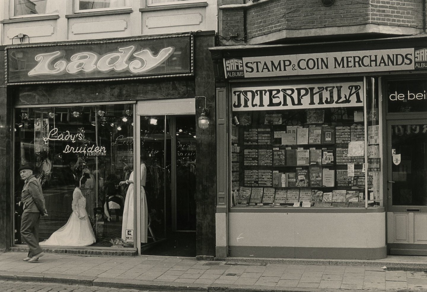 Etalages van een winkel van bruidskleding Lady en filateliewinkel Interphila in Gent