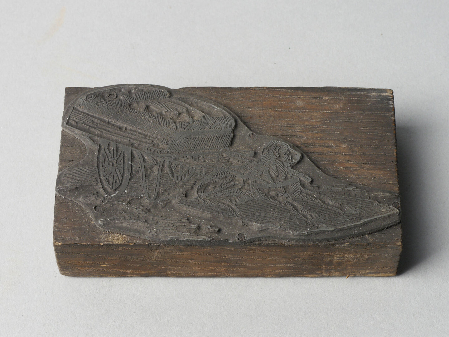 Lijncliché met afbeelding van trekhond en geladen hondenkar