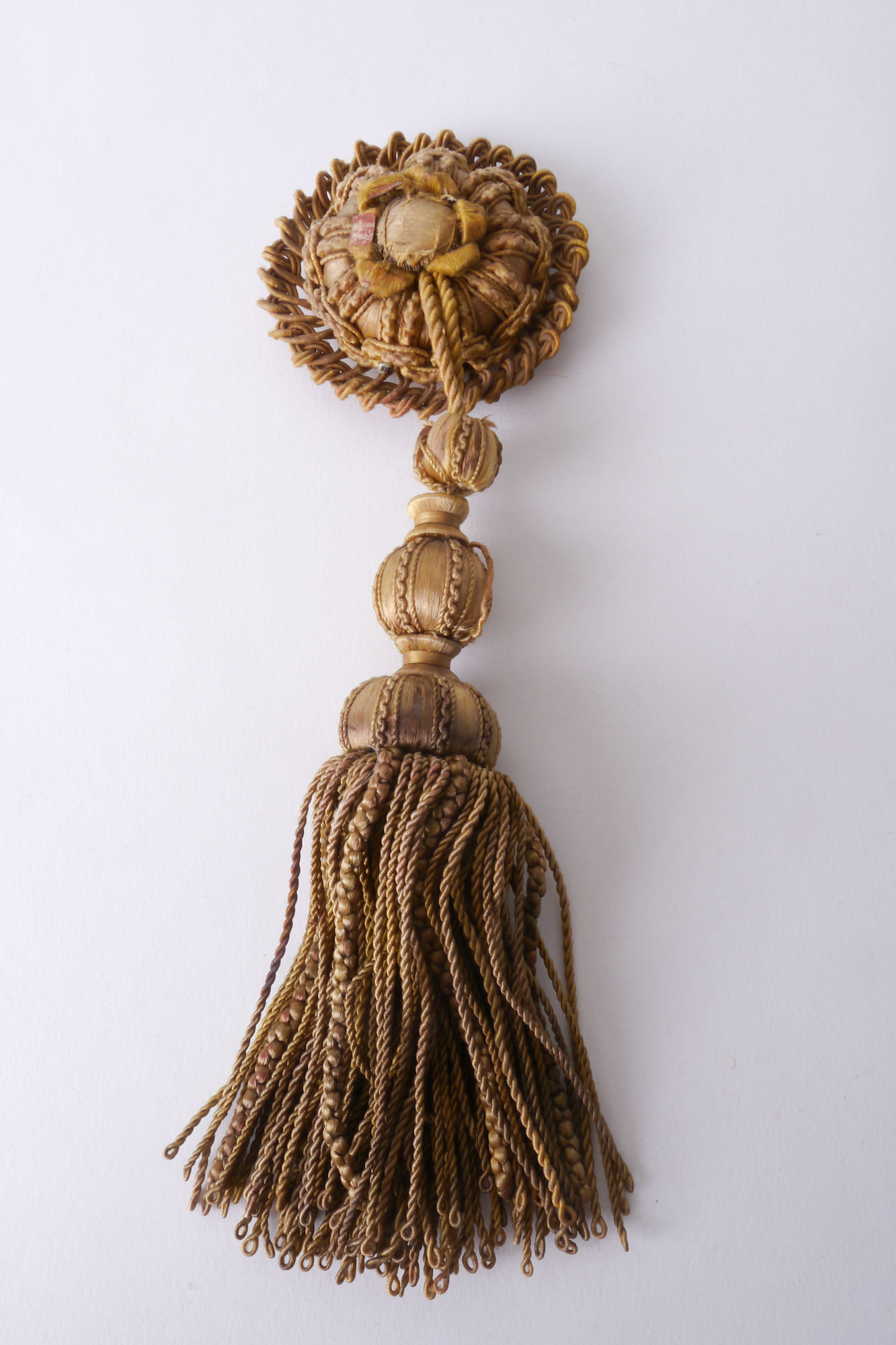 Macaron of rozet met kwast als onderdeel voor het vervaardigen van passement