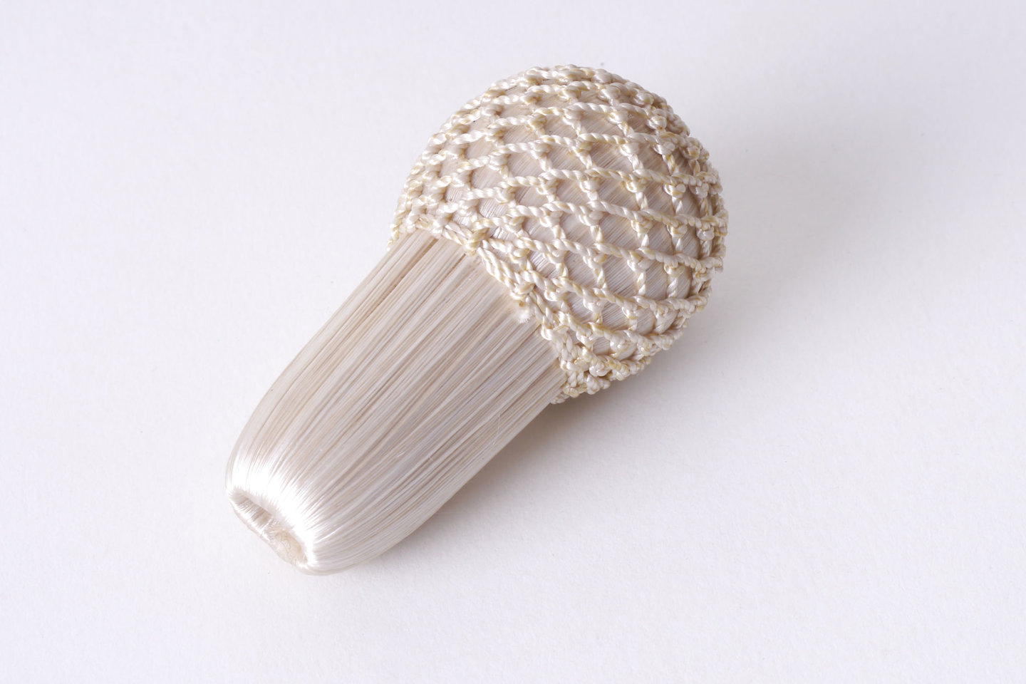 Overtrokken houten vorm als onderdeel voor het vervaardigen van passement