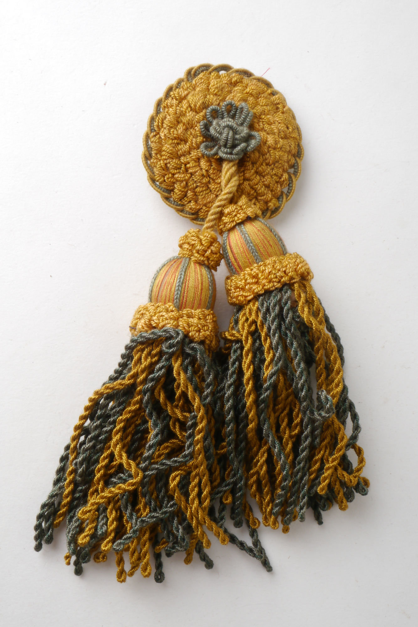 Macaron of rozet met 2 kwasten als onderdeel voor het vervaardigen van passement