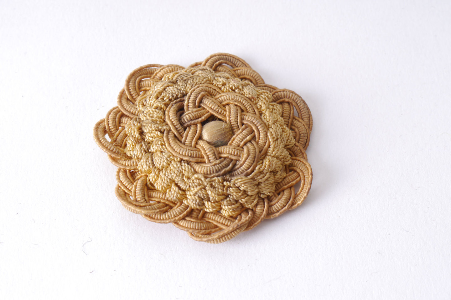 Macaron of rozet als onderdeel voor het vervaardigen van passement